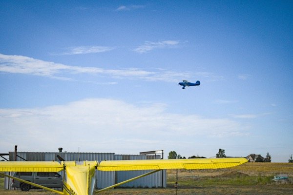 An aircraft in flight above the airpark