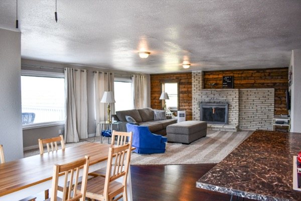 Dining area and living room with large windows