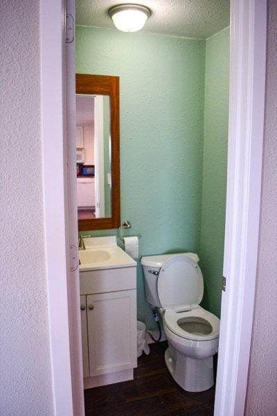 Half bathroom with vanity and toilet