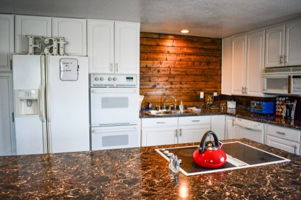 Kitchen with refrigerator and double wall ovens