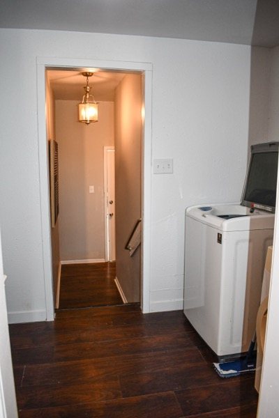 Laundry appliances beside the hallway