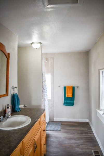 Bathroom with vanity, mirror, and towel rail