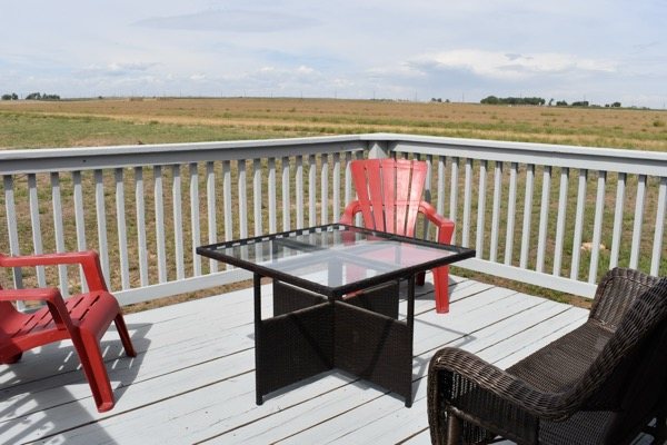 Outdoor table and red chairs on the Hangar House deck
