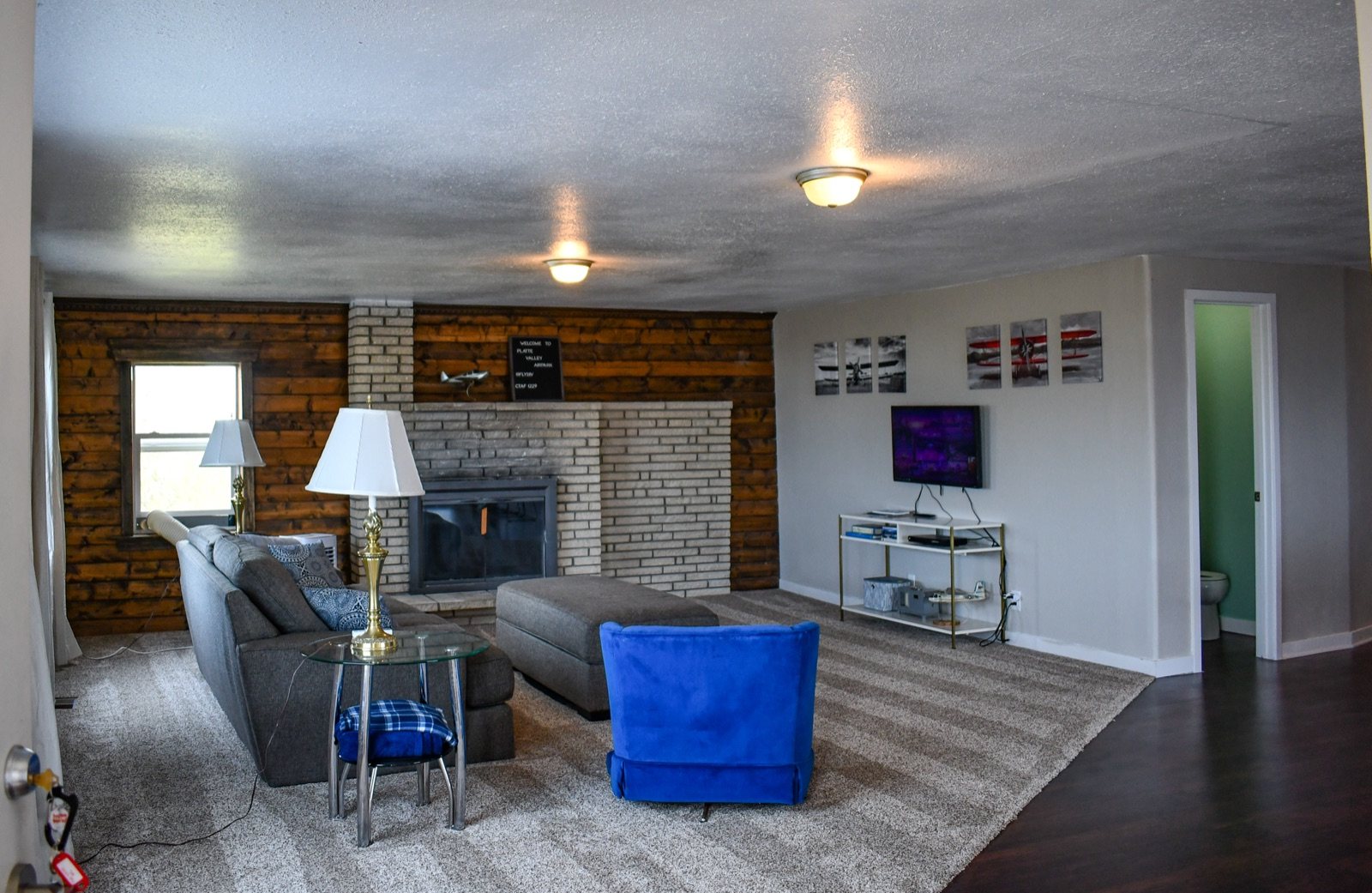 The Hangar House living room with its stone fireplace