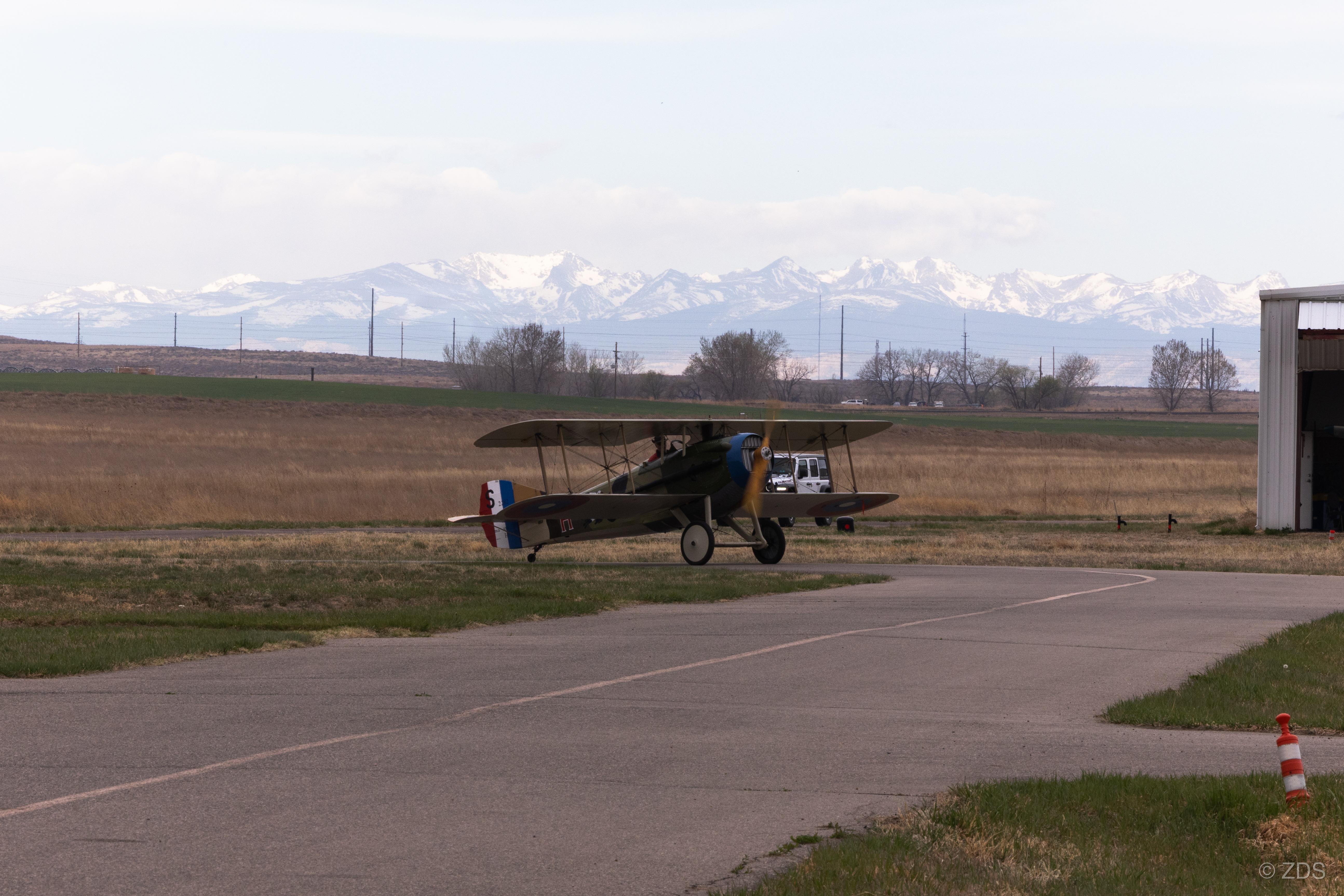 WWI biplane at Platte Valley Airpark with Rocky Mountains
